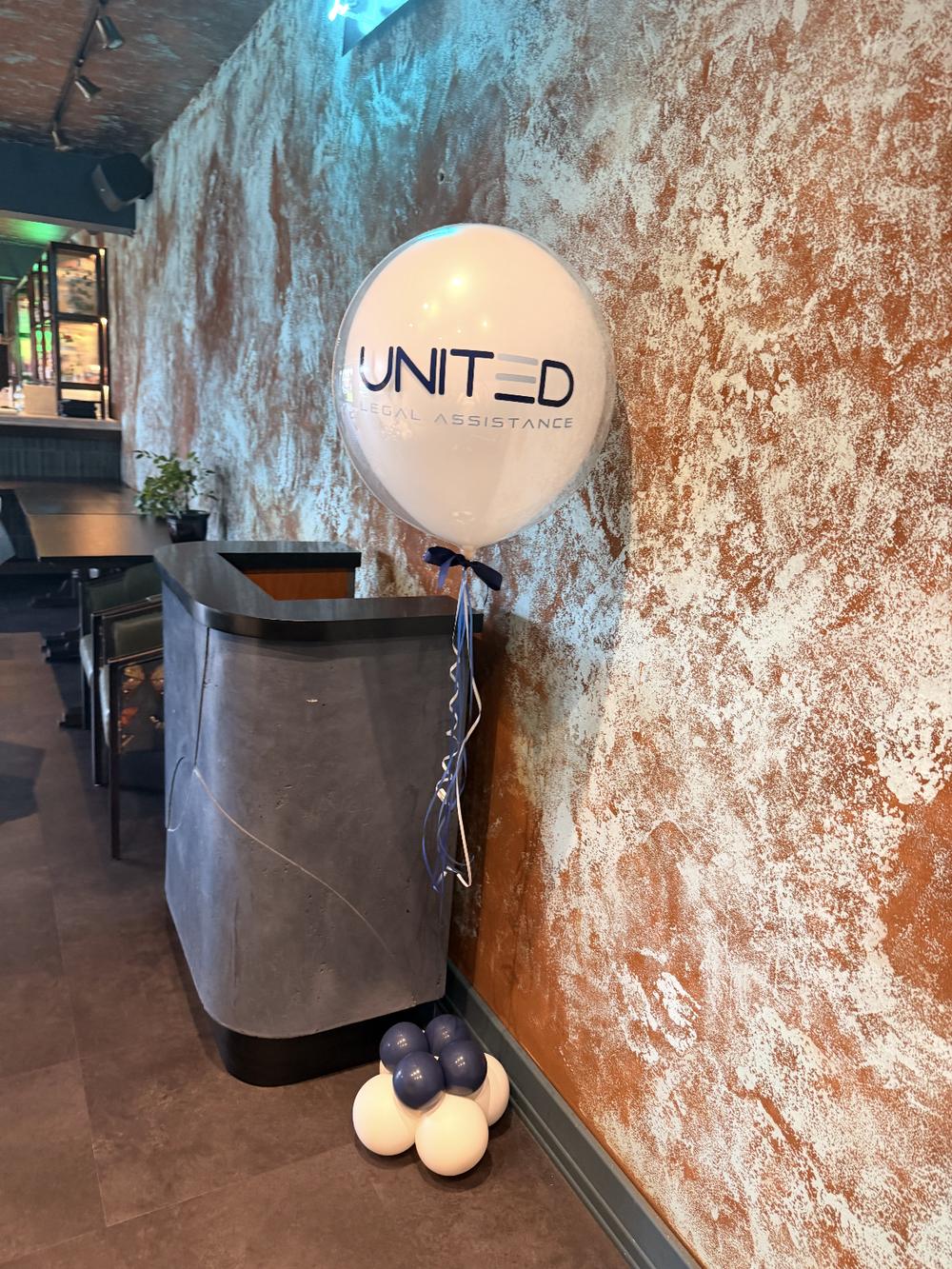 Branded United Legal Assistance balloon on a mini balloon base