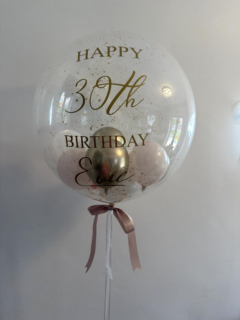 Gold confetti bubble balloon for a 30th birthday