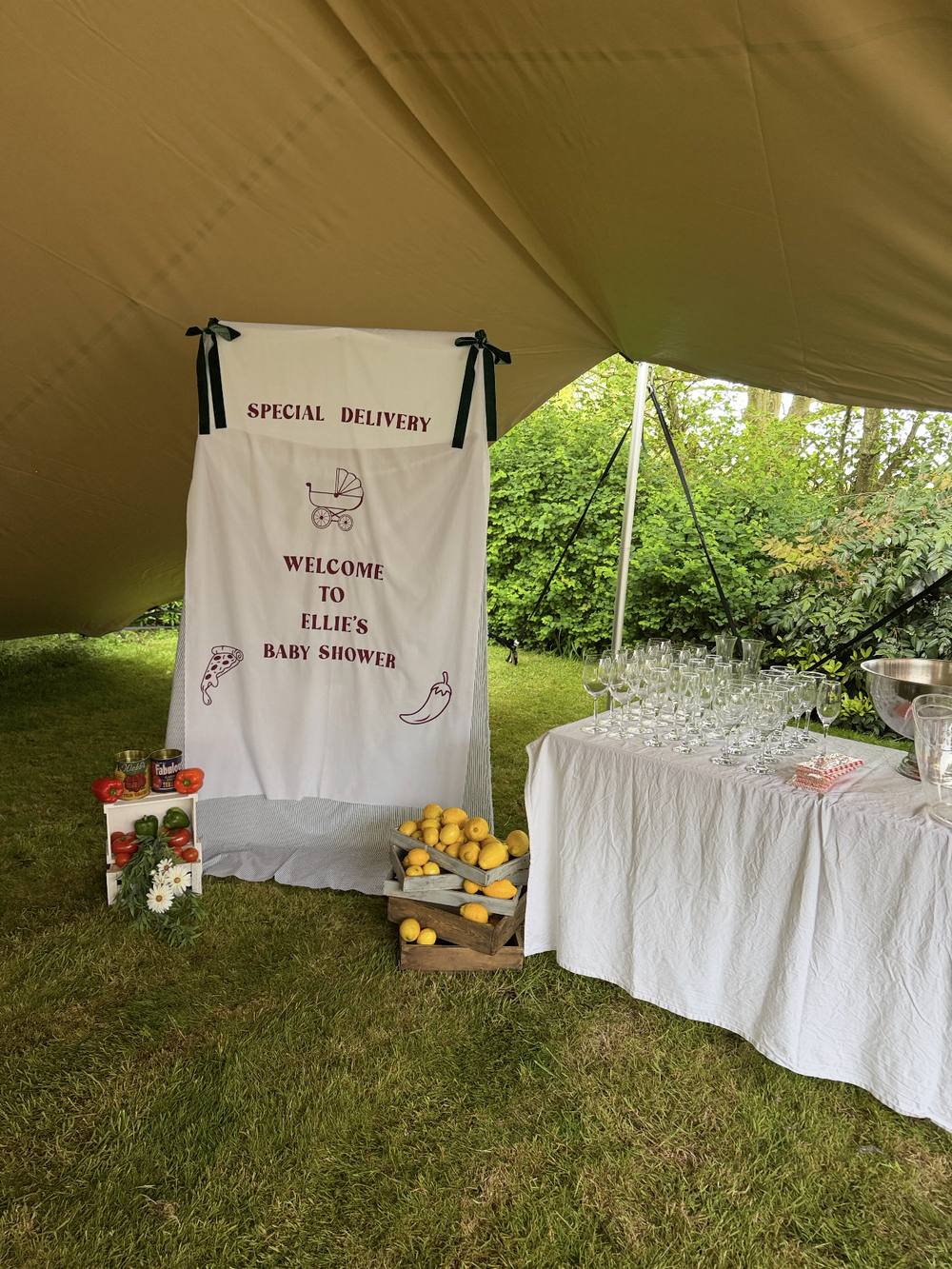 Italian market themed baby shower backdrop with fresh produce styling