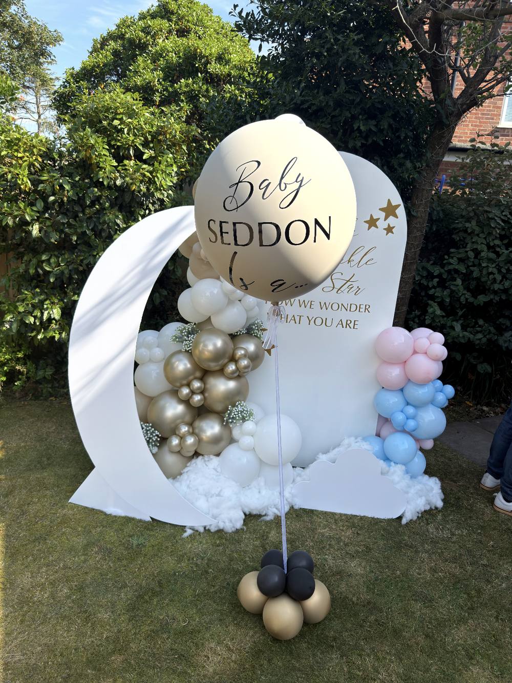 Moon and cloud balloon backdrop for a baby name reveal