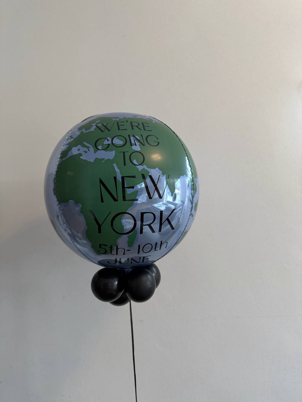 Personalised globe bubble balloon announcing a trip to New York