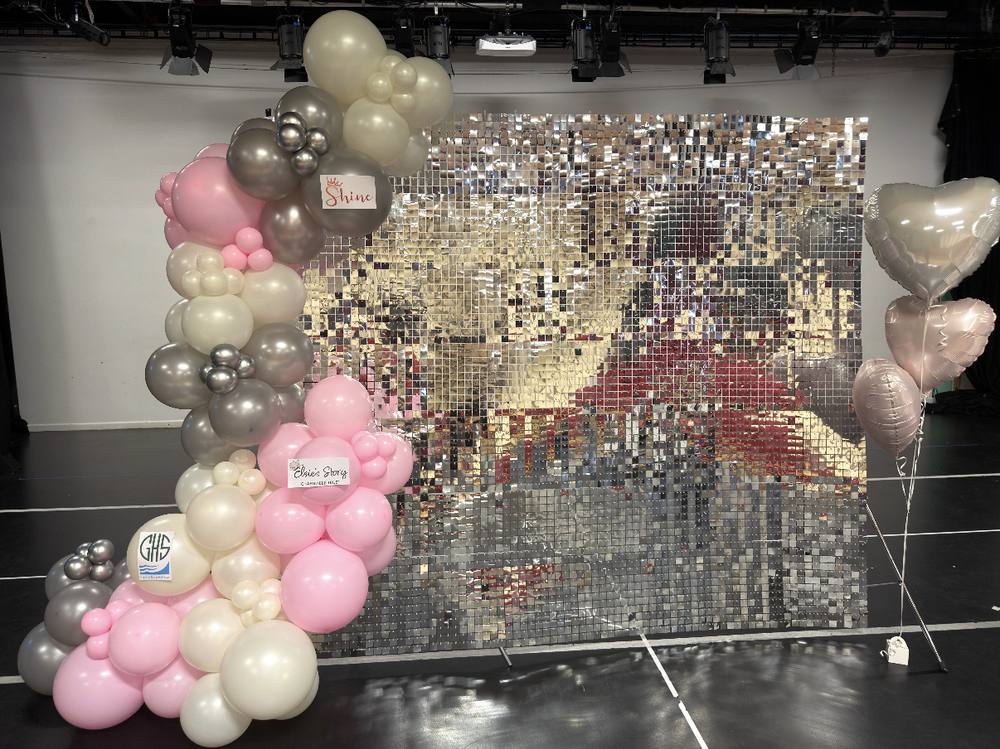 Sequin wall backdrop with balloon garland for a stage event
